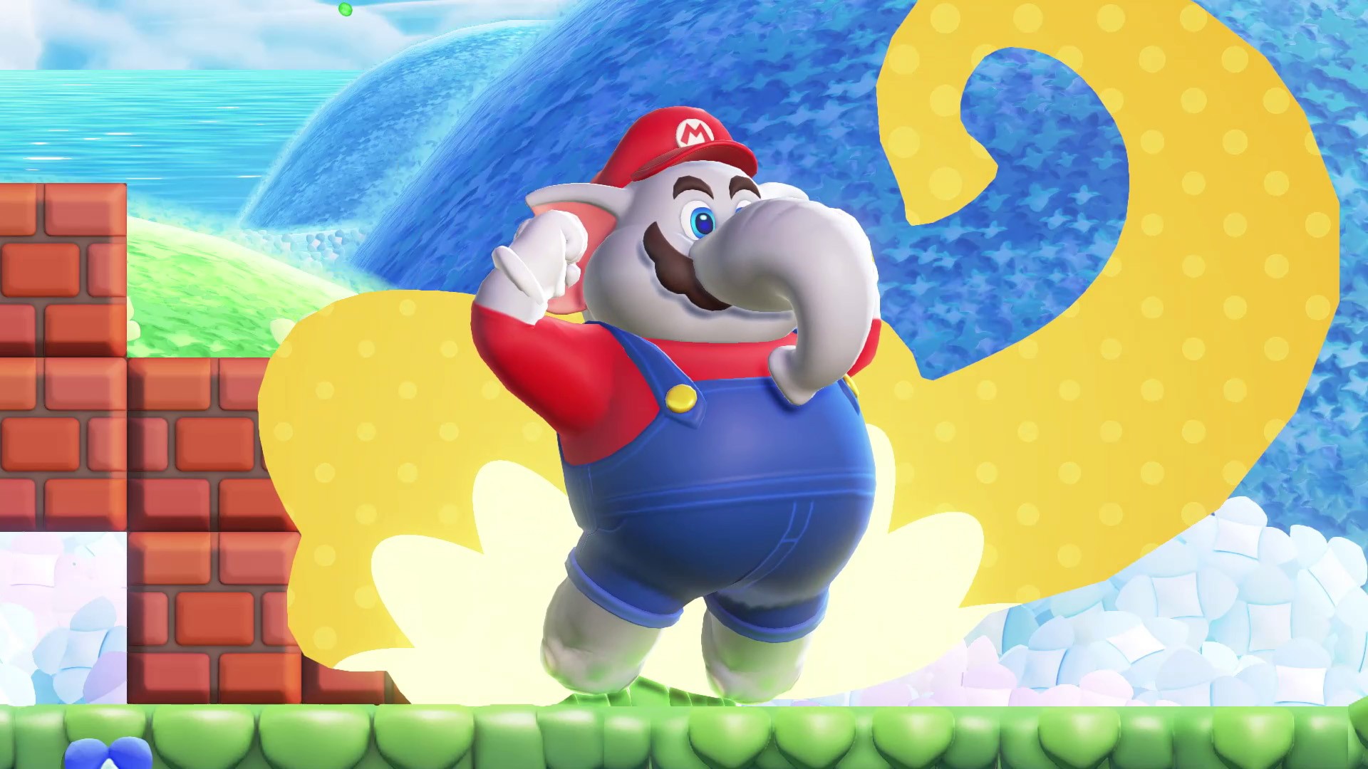Mario transformé en éléphant, le poing levé, dans un niveau de Super Mario Bros. Wonder