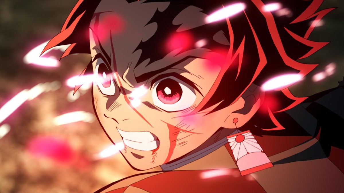 Tanjiro Kamado en gros plan, le regard furieux, baigné d’une lumière rouge