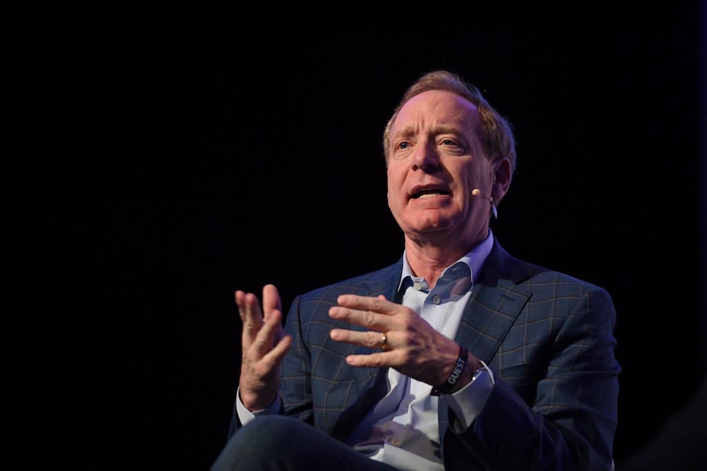 Brad Smith, vice-président de Microsoft, s’exprime sur scène en veste à carreaux