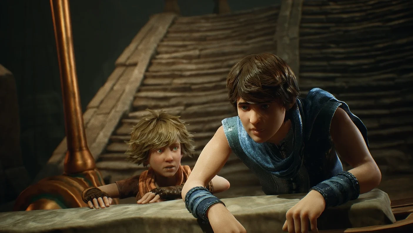 Les deux frères agrippés à un rebord de pierre dans le remake de Brothers&nbsp;: A Tale of Two Sons