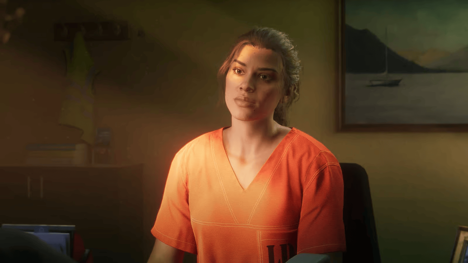 Lucia en tenue de détenue orange, assise dans un bureau, au début du trailer de GTA VI