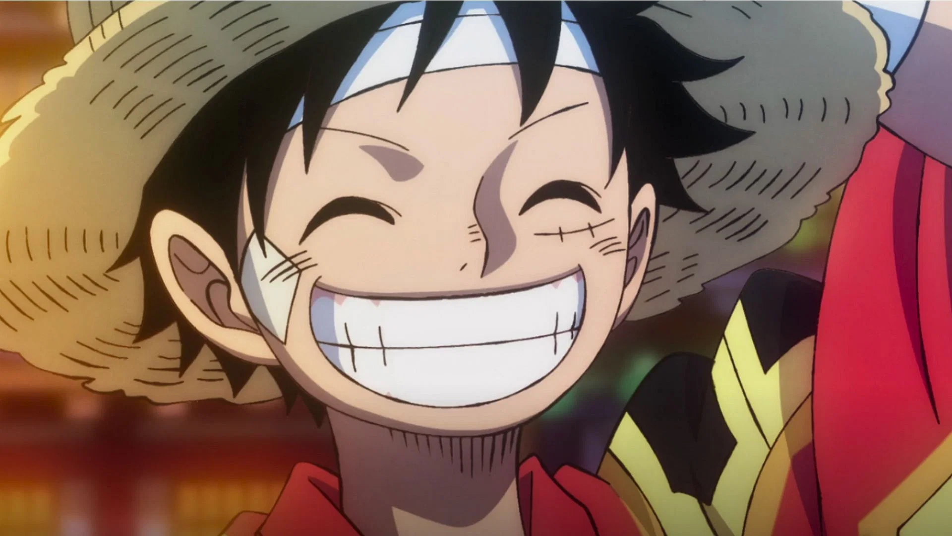 Luffy, chapeau de paille sur la tête, avec un large sourire dans l’animé One Piece