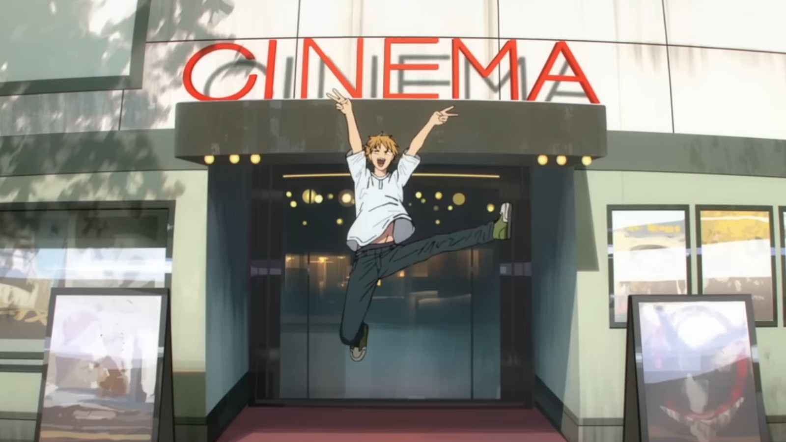 Denji saute de joie, bras levés, devant l’entrée d’un cinéma